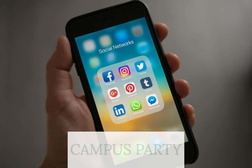 Person Holding Iphone Showing Social Networks Folder