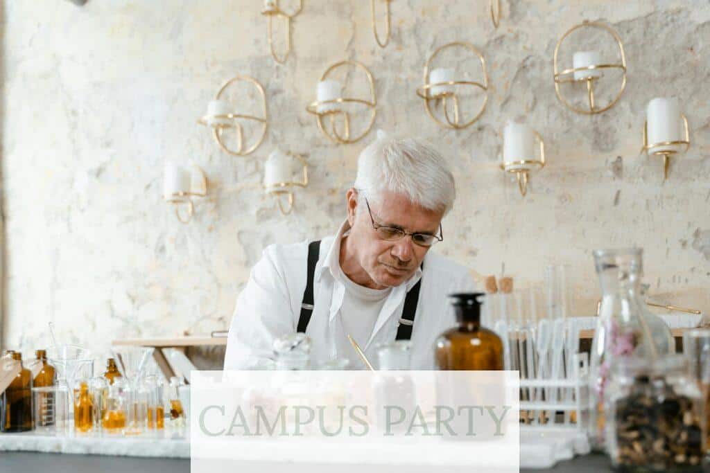 Man in White Dress Shirt Sitting on Chair in Front of Table With Bottles and Glasses