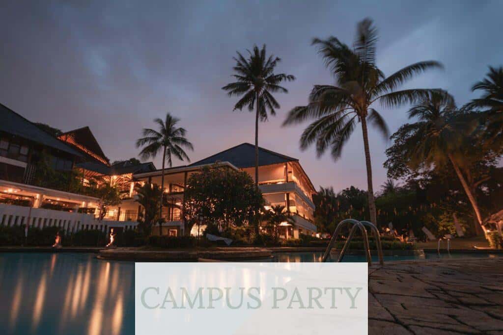 Luxurious tropical resort with swimming pool and palms at dusk, perfect for a tranquil vacation.